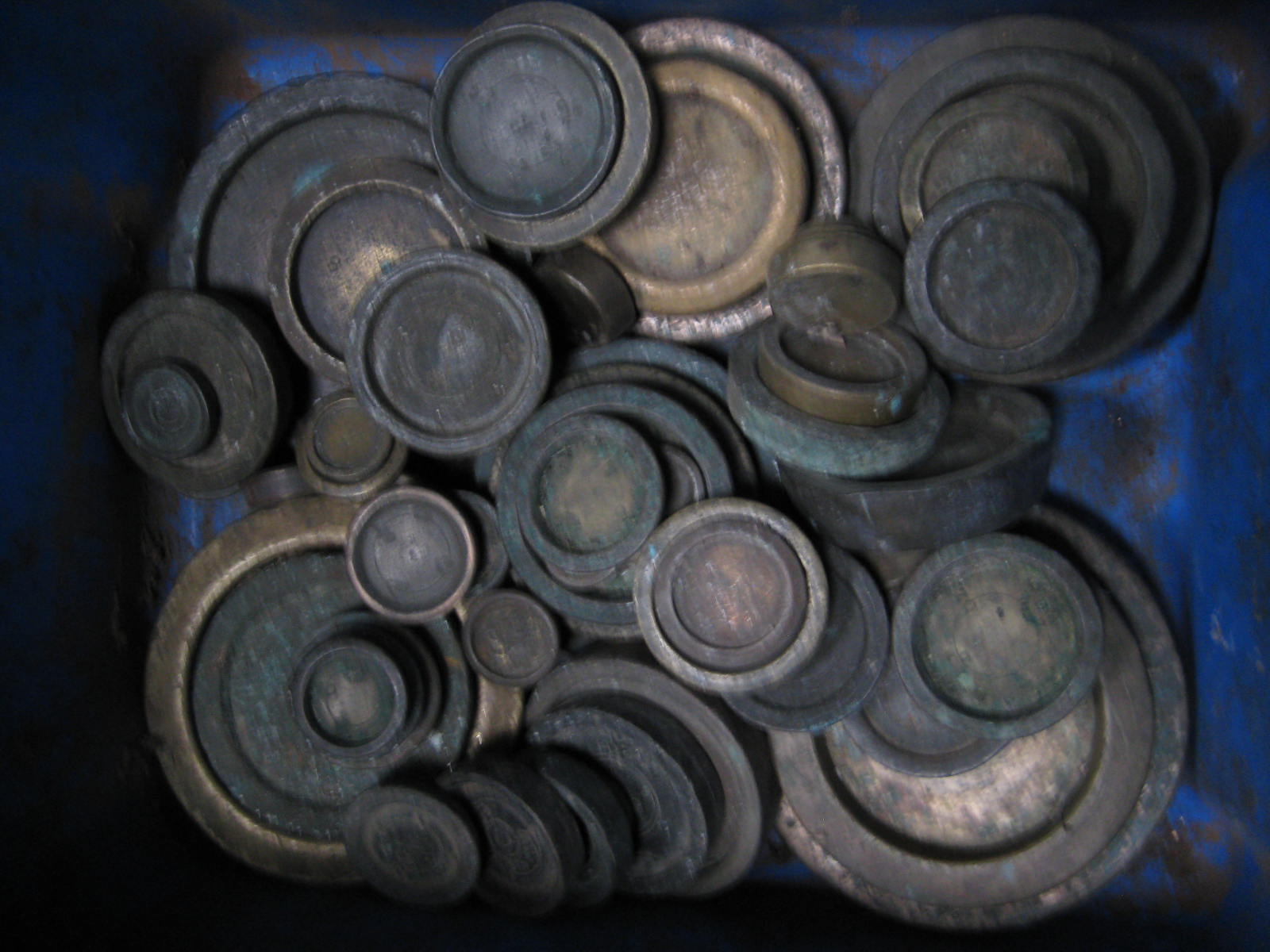 A tub of various brass weights