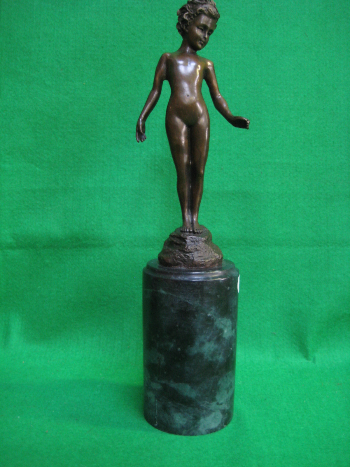 A bronzed figure of a nude, on marble base