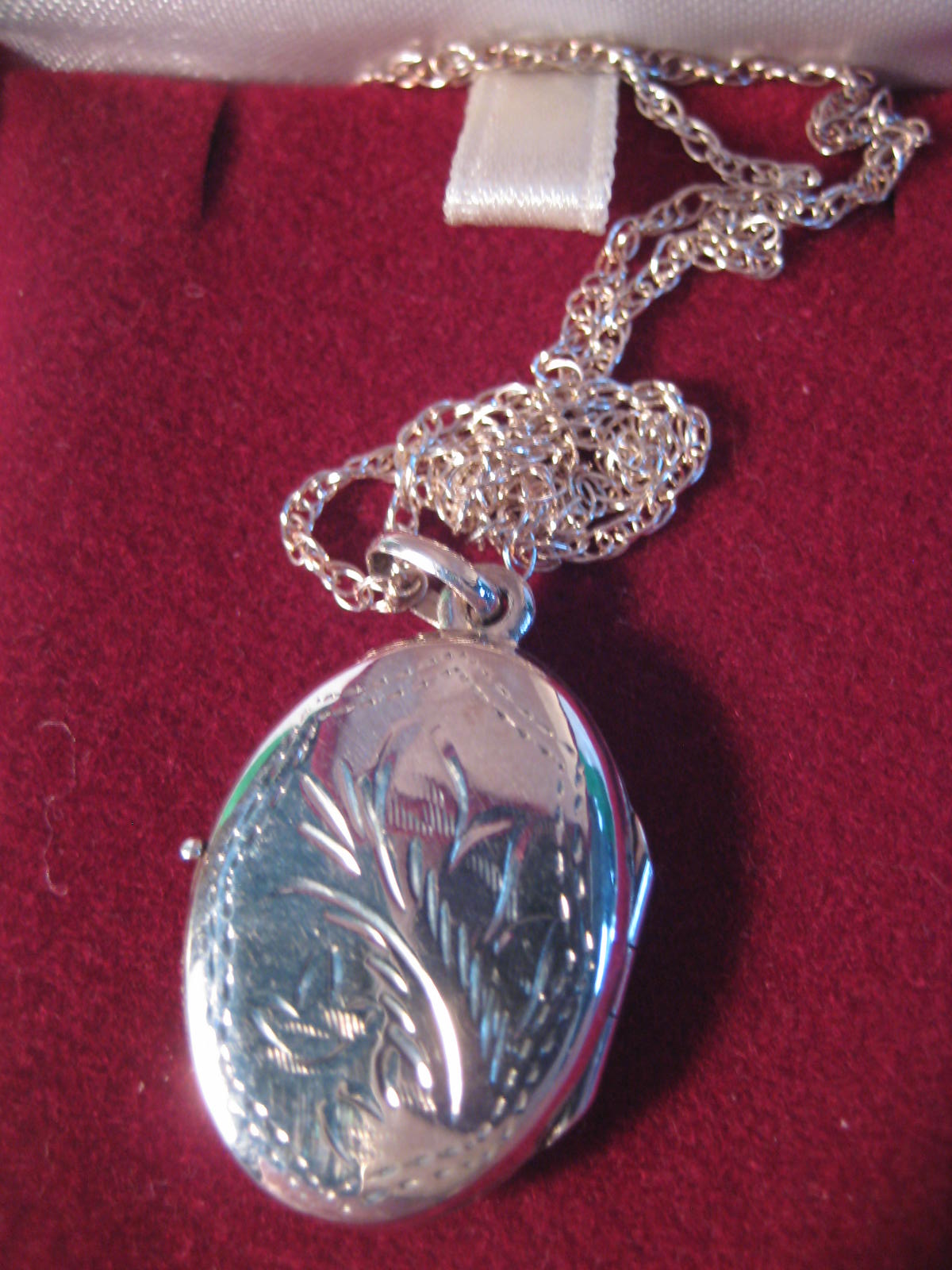 A boxed silver locket and chain