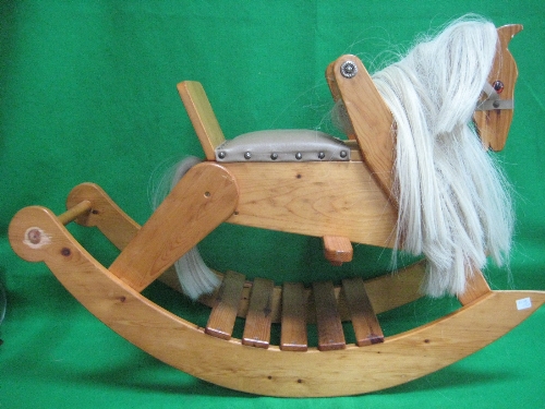 A  child`s pine rocking horse with saddle and bridle