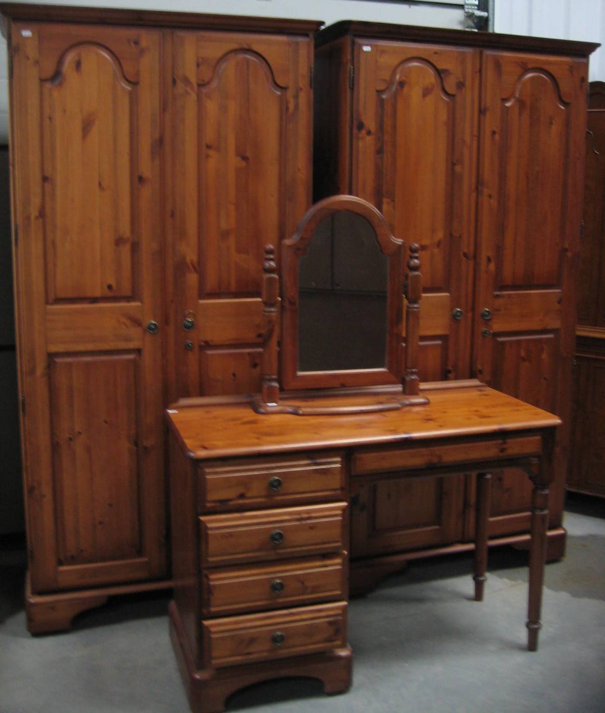 A pair of Ducal pine wardrobes, and a similar dressing table with mirror
