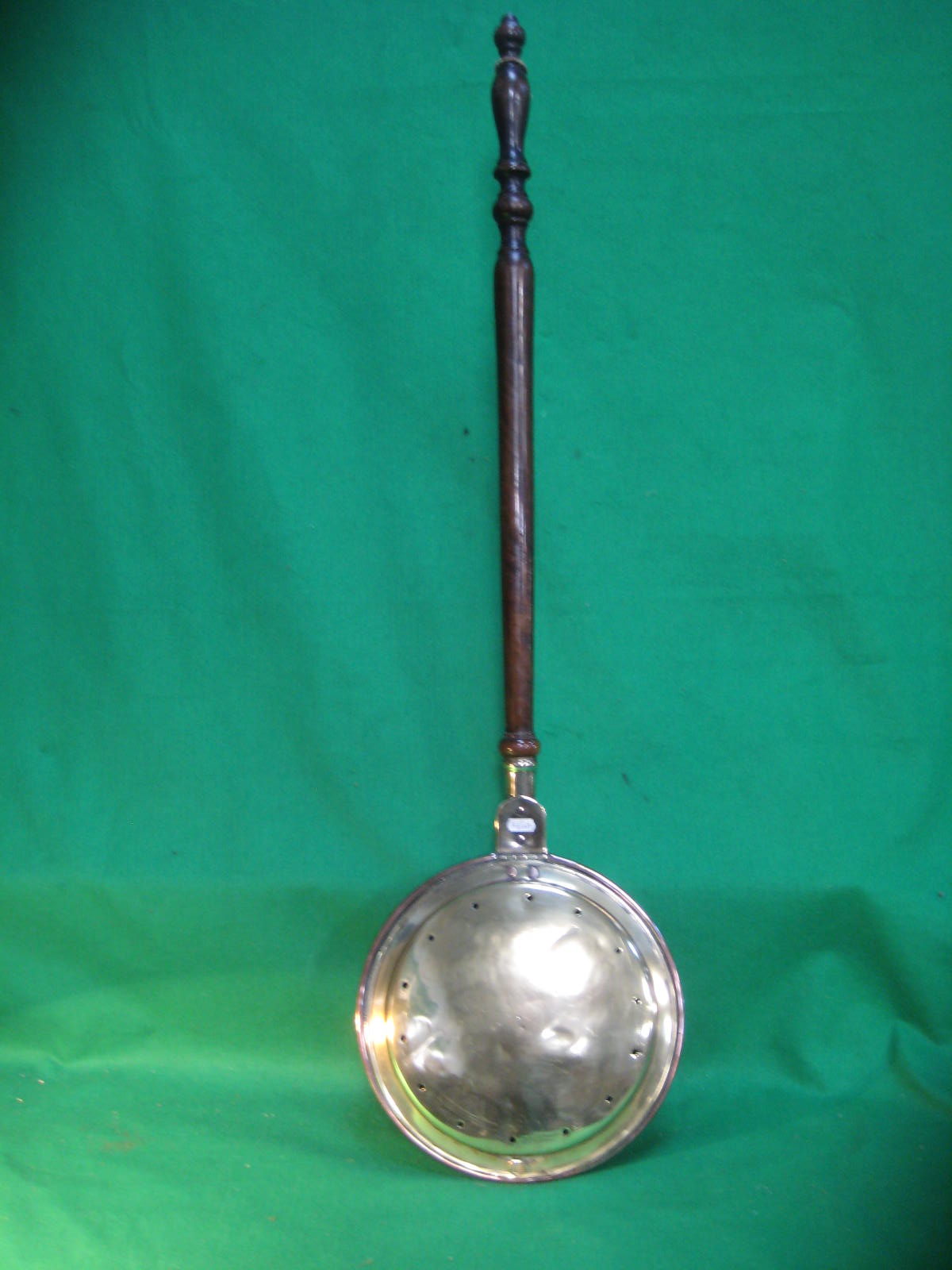 A Victorian brass warming pan with turned wood handle