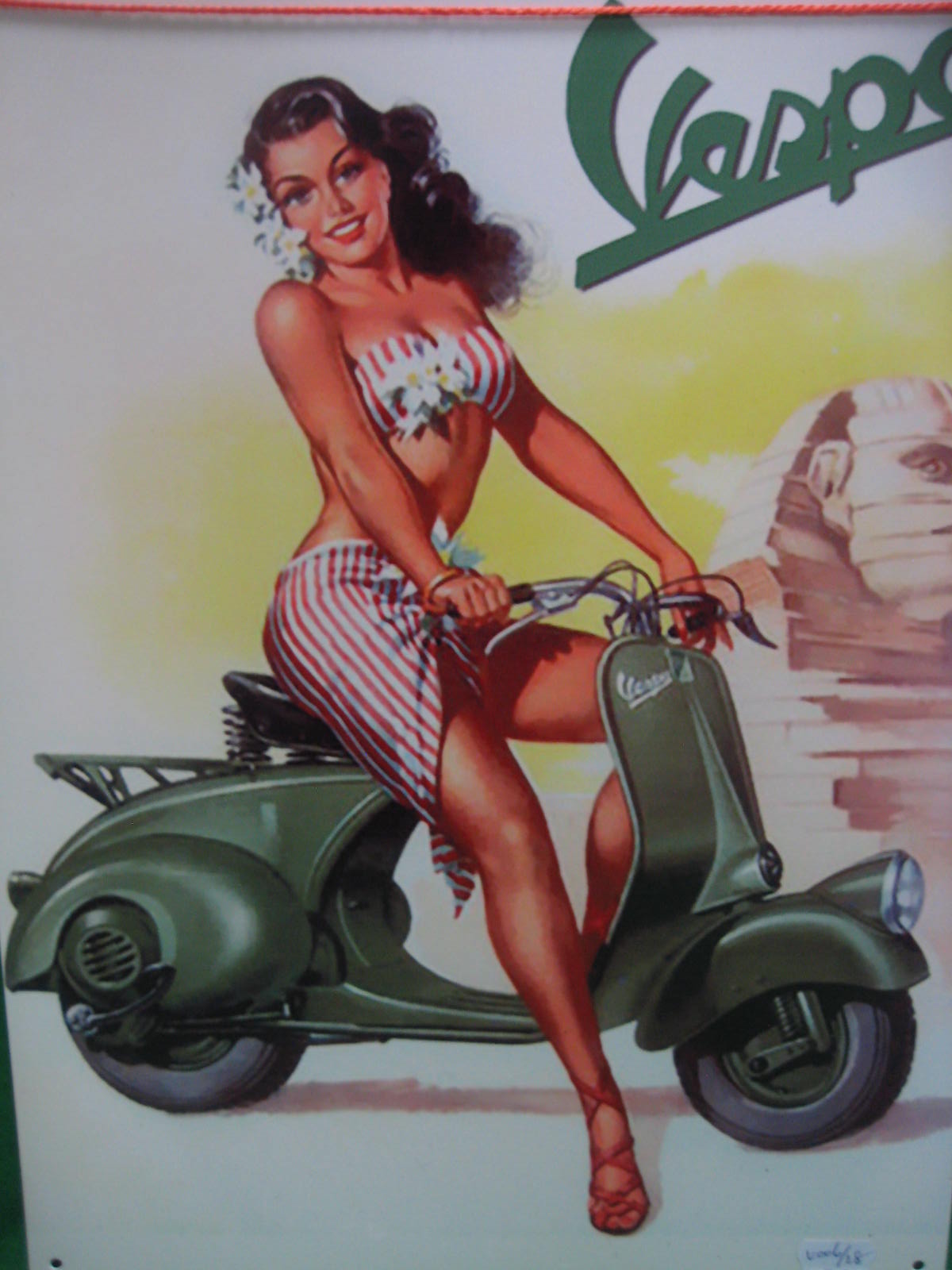 A tin advertising sign Vespa scooters