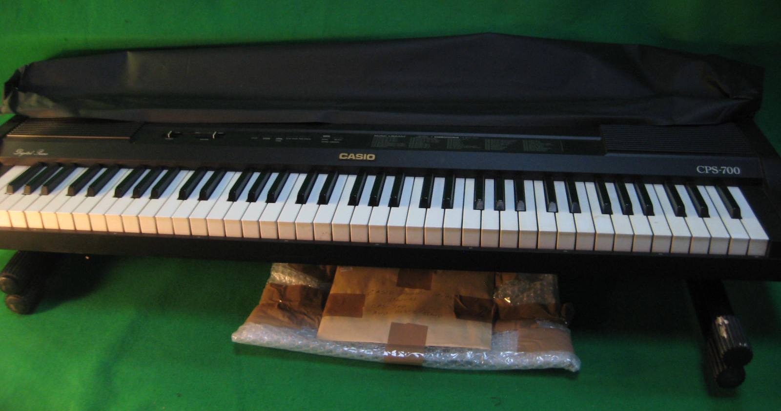 A Casio keyboard, stand and manual