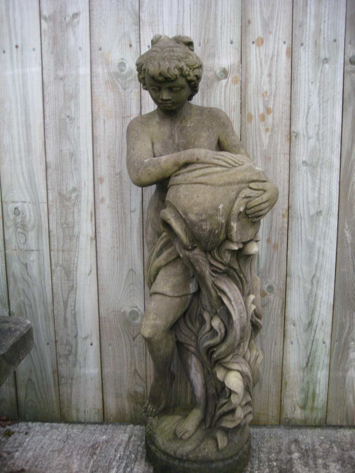 A stone garden statue of a maiden with amphora 125 cms high