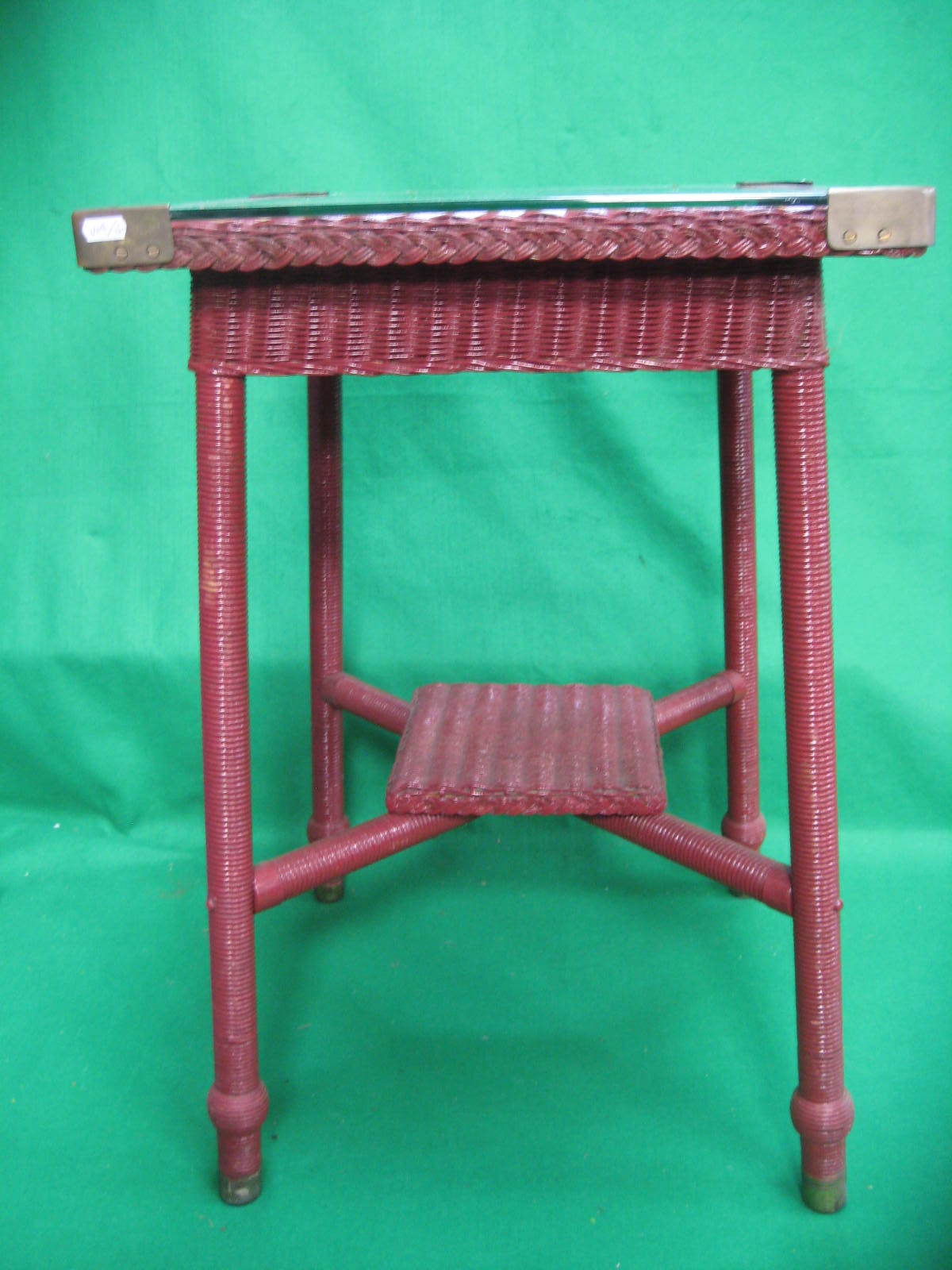 A red painted Lloyd Loom two tier side table with glass top