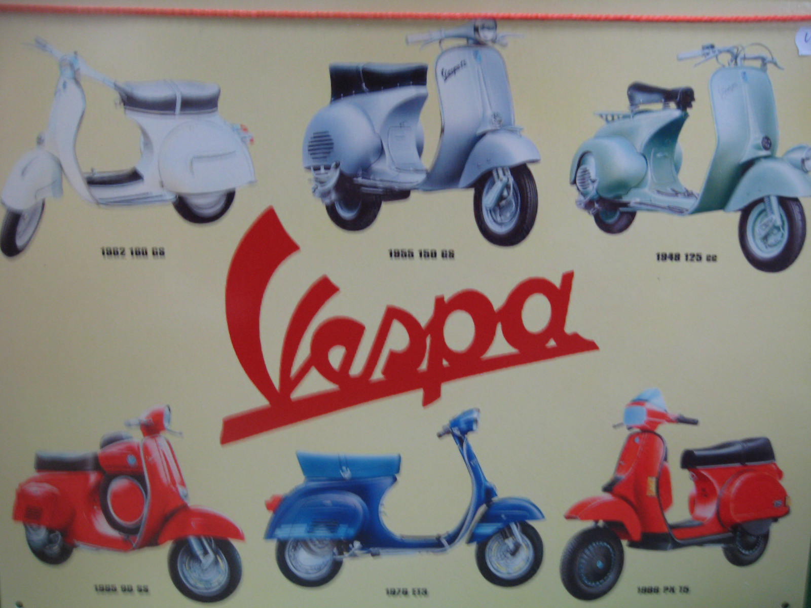 A tin advertising sign Vespa scooters