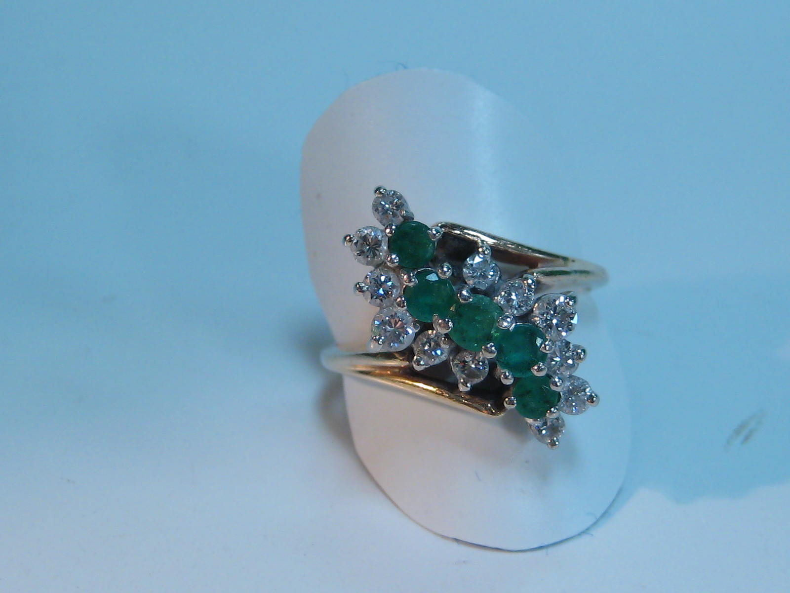 A 14ct gold stylised 12-diamond and 5-emerald ring