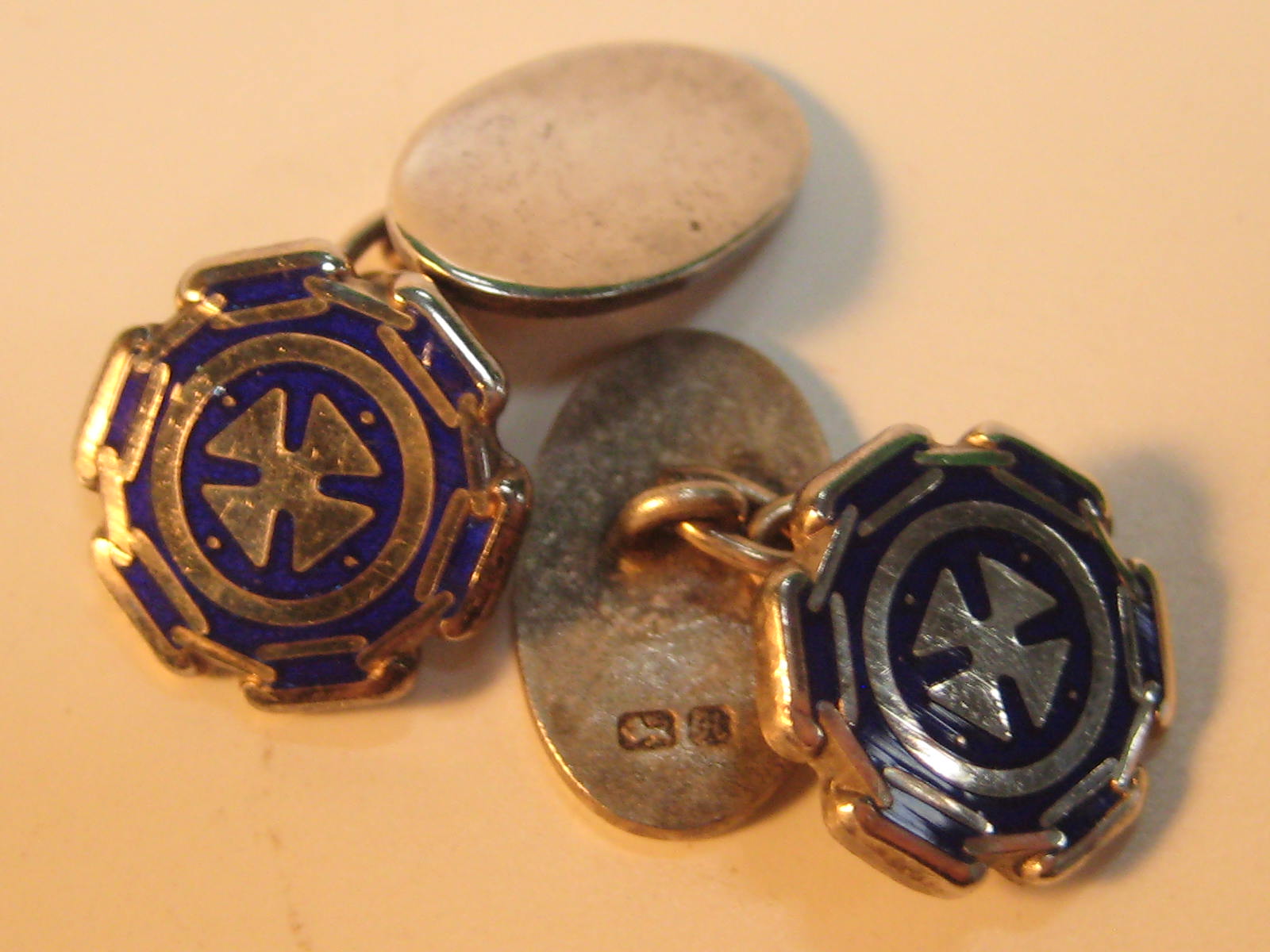 A pair of silver and blue enamel cufflinks