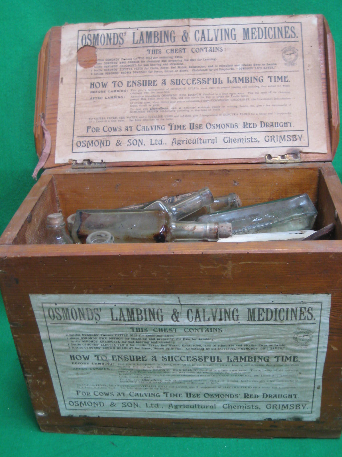 A medecine box containing a quantity of old bottles