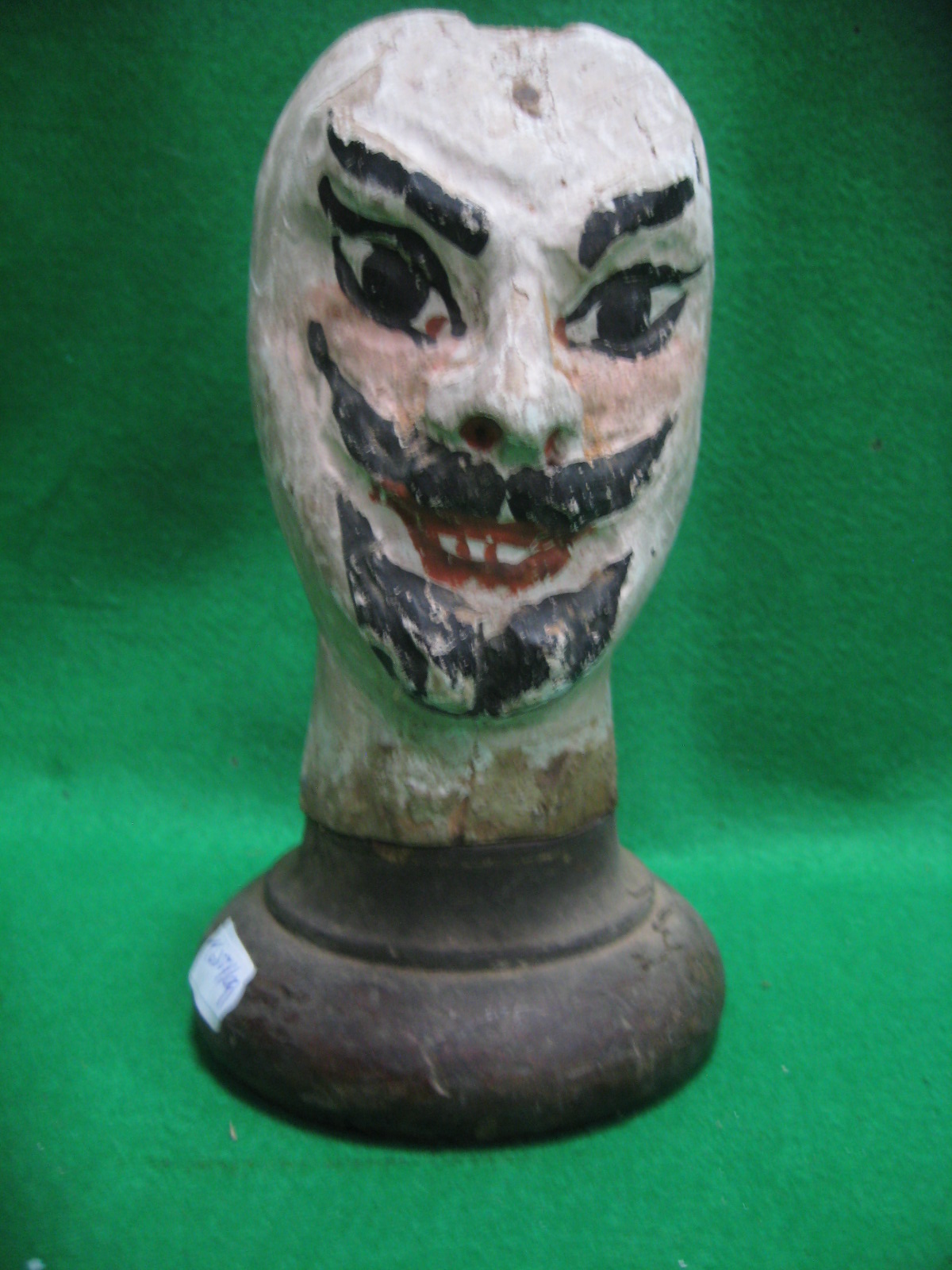 A mounted old wood puppet head