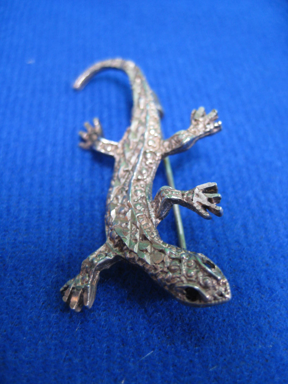 A silver lizard brooch