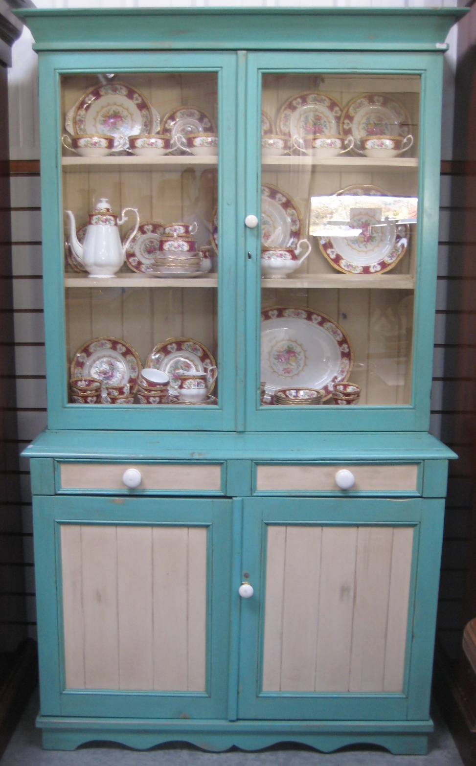 A painted pine kitchen dresser having glazed cupboard doors above  two drawers and  cupboards on