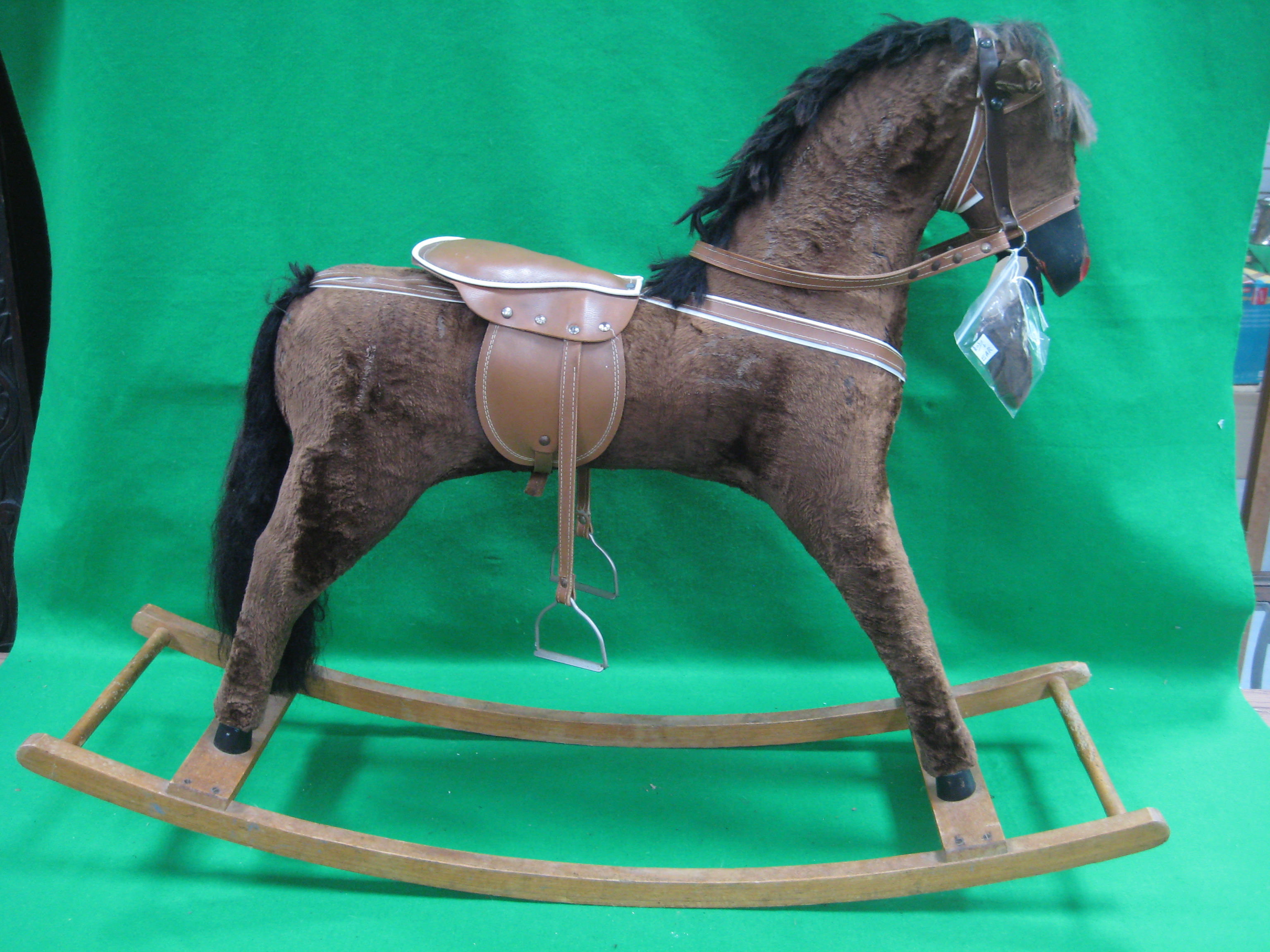 A rocking horse with bridle and saddle