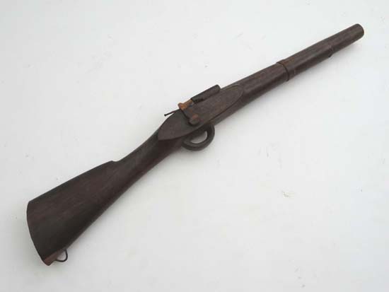 Native Tribal Military : A child`s walnut carved rifle, likely modelled on the Brown Bess musket. 20
