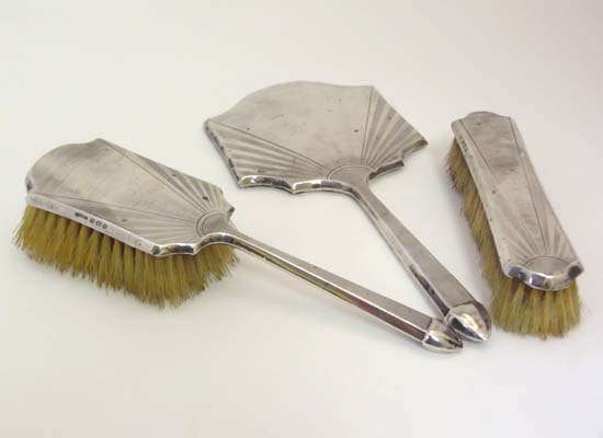 An Art Deco 3 piece matched HM silver dressing table set comprising mirror and 2 brushes with