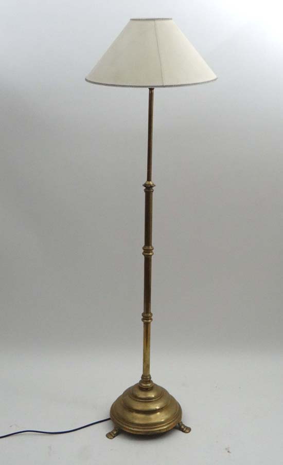 A 19thC brass ( former gas lamp ) telescopic standard lamp with cylindrical column, circular stepped