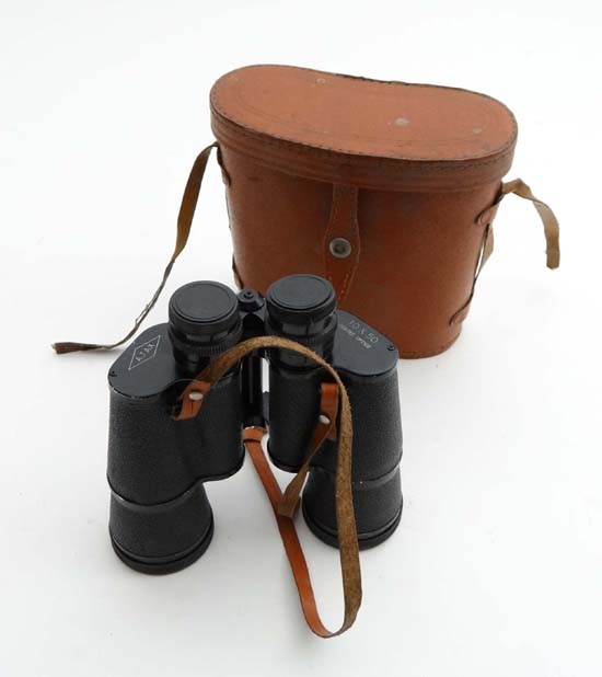 A pair of AJAX, 10 X 50, binoculars complete with lens covers in a leather case