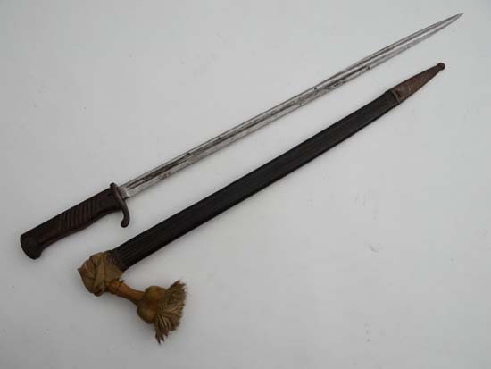 A German WW1 W.K&C Solingen bayonet, complete with leather and white metal sheath. Bear indistinct