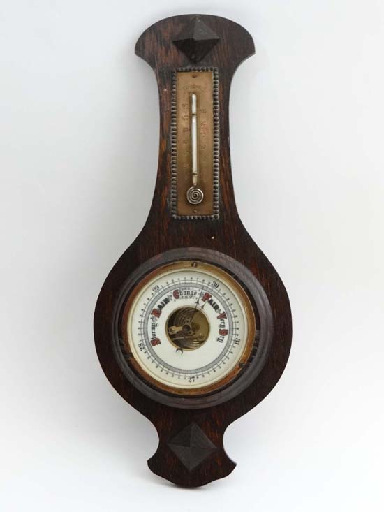 Barometer: An oak cased barometer circa 1900, with a clock face weather and air pressure dial and