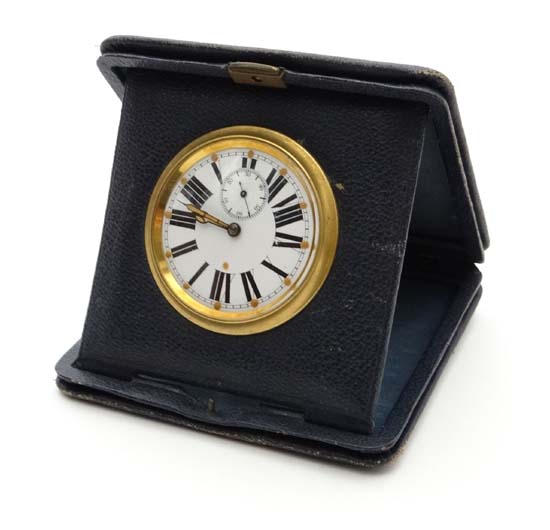A Swiss made blue leather folding travel clock with enamel dial and luminous hands and hour
