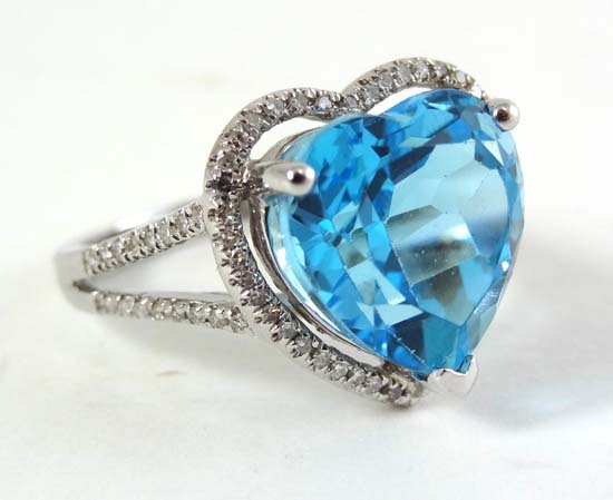 A 14k white gold and diamond ring set with a heart shape blue topaz
