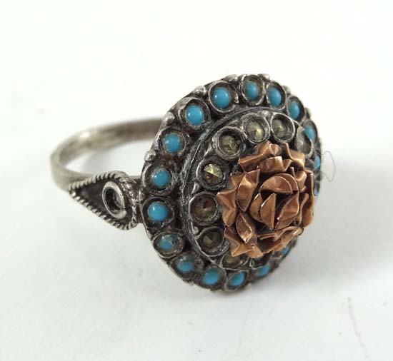 A .800 silver ring with turquoise marcasite and gilt metal decoration
