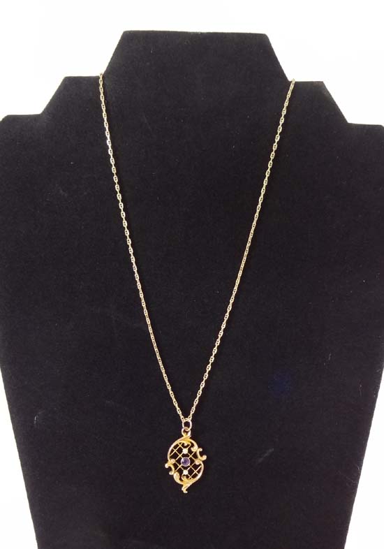 A 9ct gold pendant and chain the Art Nouveau pendant set with seed pearls and amethysts