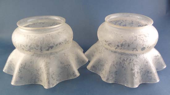 A pair of acid etched foliate decorated flared wavy ring glass light shades. 8" at widest.