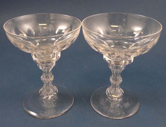 A pair of crystal glass champagne saucers with facet cut and air inclusion decoration 5" high