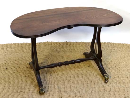 A Contemporary mahogany kidney shaped lyre ended four footed low table 33 1/2" wide