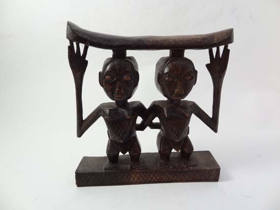 An African native tribal carved wooden neck rest in the form of 2 female figures 7" high