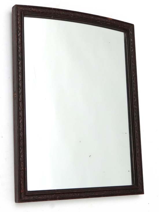 An early 20thC carved wooden bordered wall mirror 21 1/2" high x 16" wide