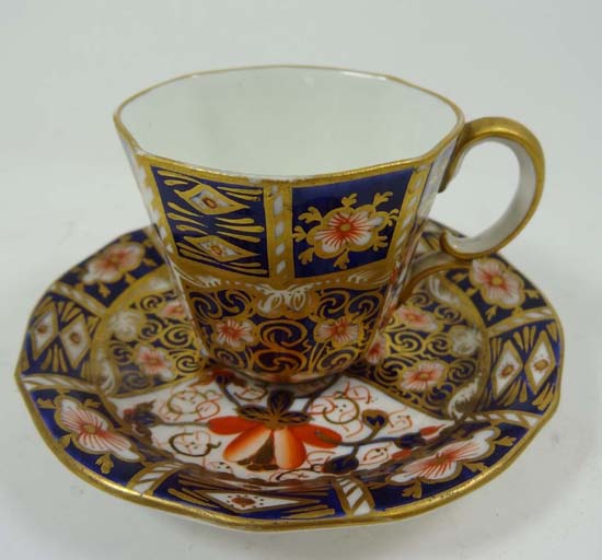 A Royal Crown Derby cup and saucer decorated in Imari palette with gilded detail.