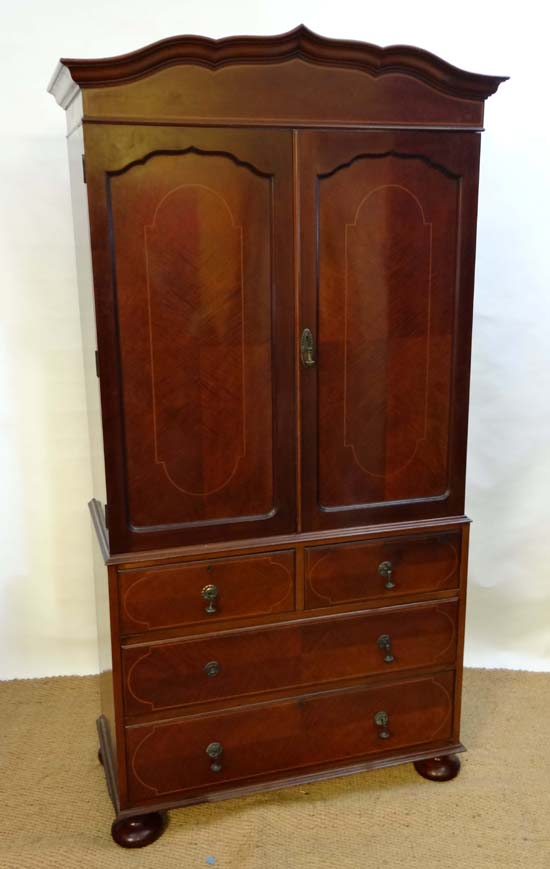 A 19thC checker inlaid mahogany linen press opening to reveal 4-shelves over 2-short and 3 long