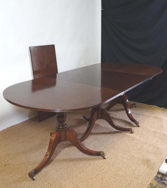 A c.1800 Georgian mahogany triple pedestal D-ended extending dining table with reeded decoration,