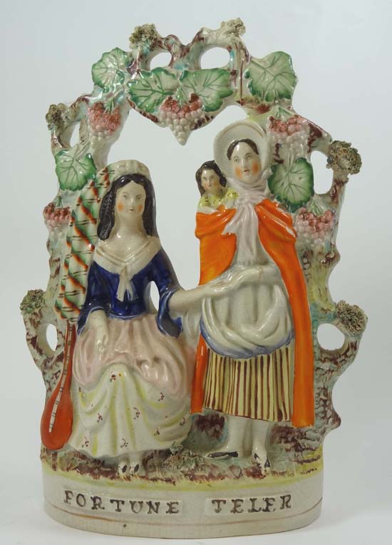 A mid 19thC Victorian Staffordshire polychrome figure entitled Fortune Teler, depicting a seated