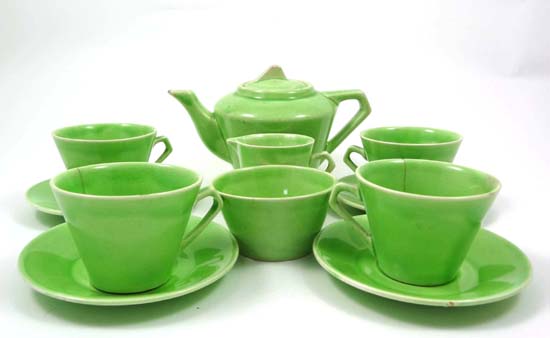 A C1930s Art Deco style child`s teaset by Wadeheath for Walt Disney decorated with a green glaze,