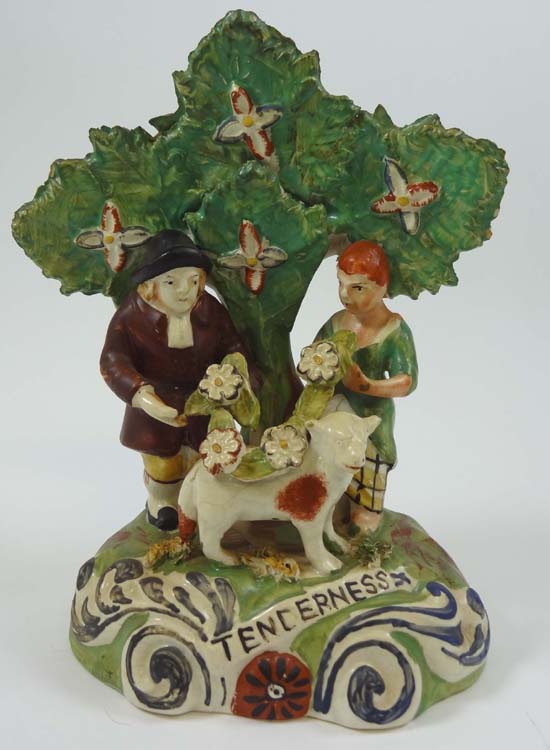 A 19thC Staffordshire figure entitled Tenderness depicting and male and female figure decorating