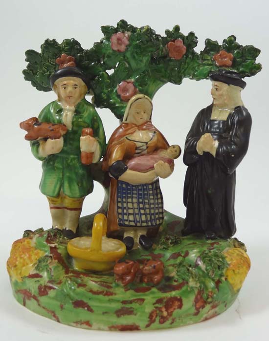 A 19thC Staffordshire bocage figure of the Tithe Pig Group, depicting vicar, woman cradling an
