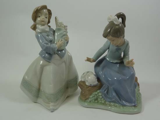 Nao porcelain figurines comprising one depicting a girl seated on a log with a puppy together with