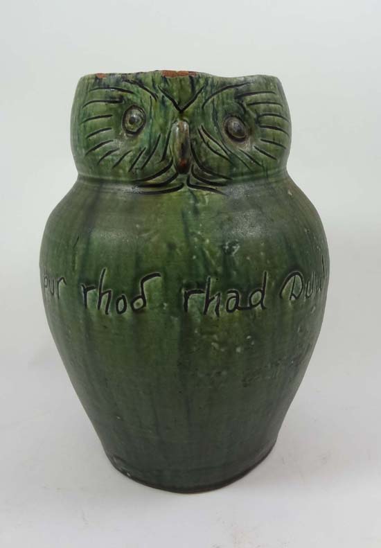 An early 20thC novelty Manner of Ewenny ale jug in the form of an owl with incised detail, glazed