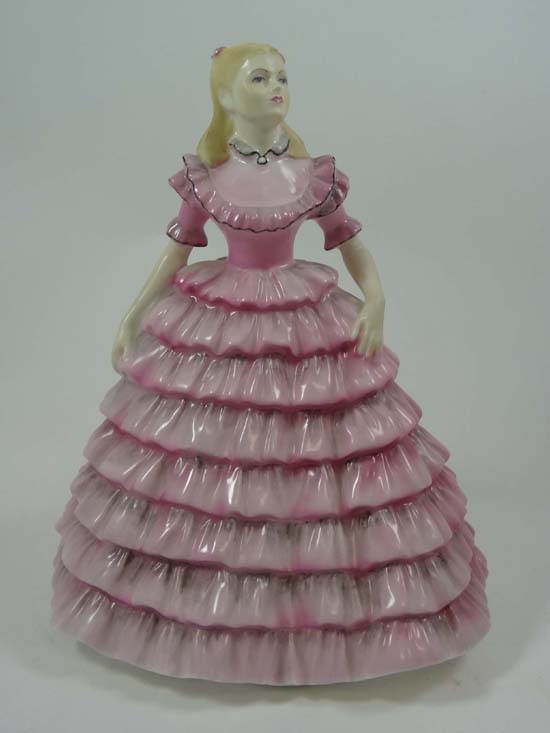 A Coalport figurine entitled First Dance from the Ladies of Fashion Series. Height 9"