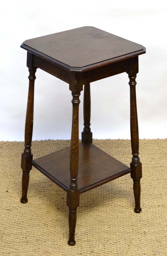 An oak 2-tier four legged side table 28 1/2" high