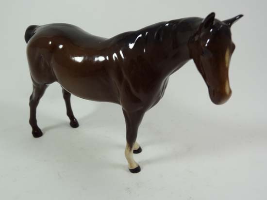 A Royal Doulton model of a bay horse with Doulton stamp to base. Approx 6" long.