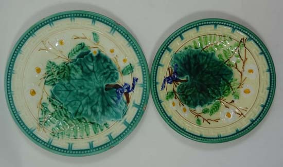 Two graduated majolica polychrome plates moulded with leaves and having floral and fern accents