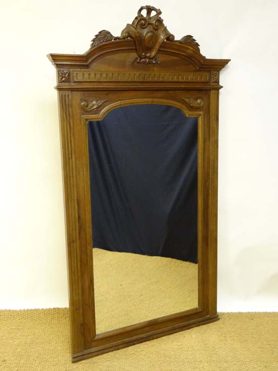A late 19thC French Empire walnut tall wall mirror with carved crest 69 1/2" high x 39 1/2" wide