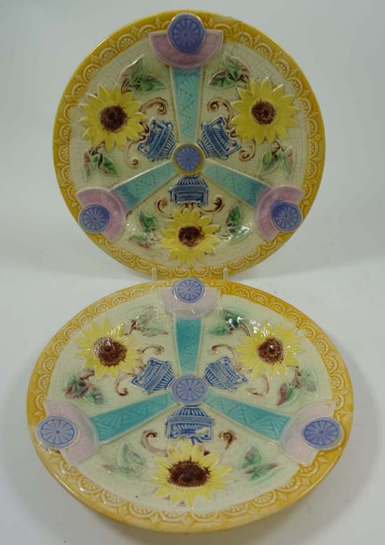 A pair of polychrome majolica plates decorated with moulded radiating design depicting sunflowers