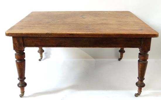 A Victorian pine kitchen table of near square from ( work table / library table) standing on