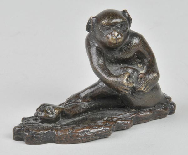 *A Japanese bronze monkey, Meiji period, finely detailed with its leg outstretched and foot